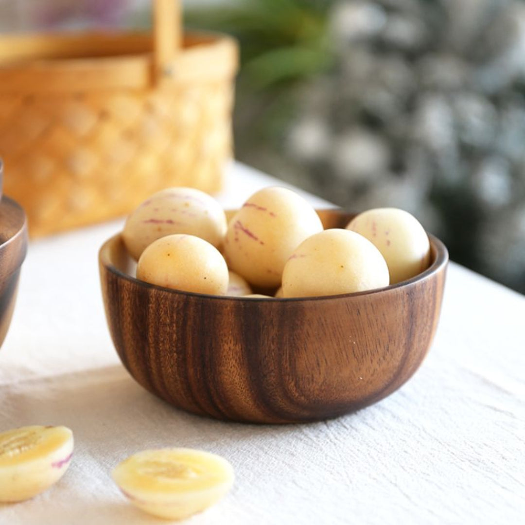 Wooden bowl filled with potatoes on a table