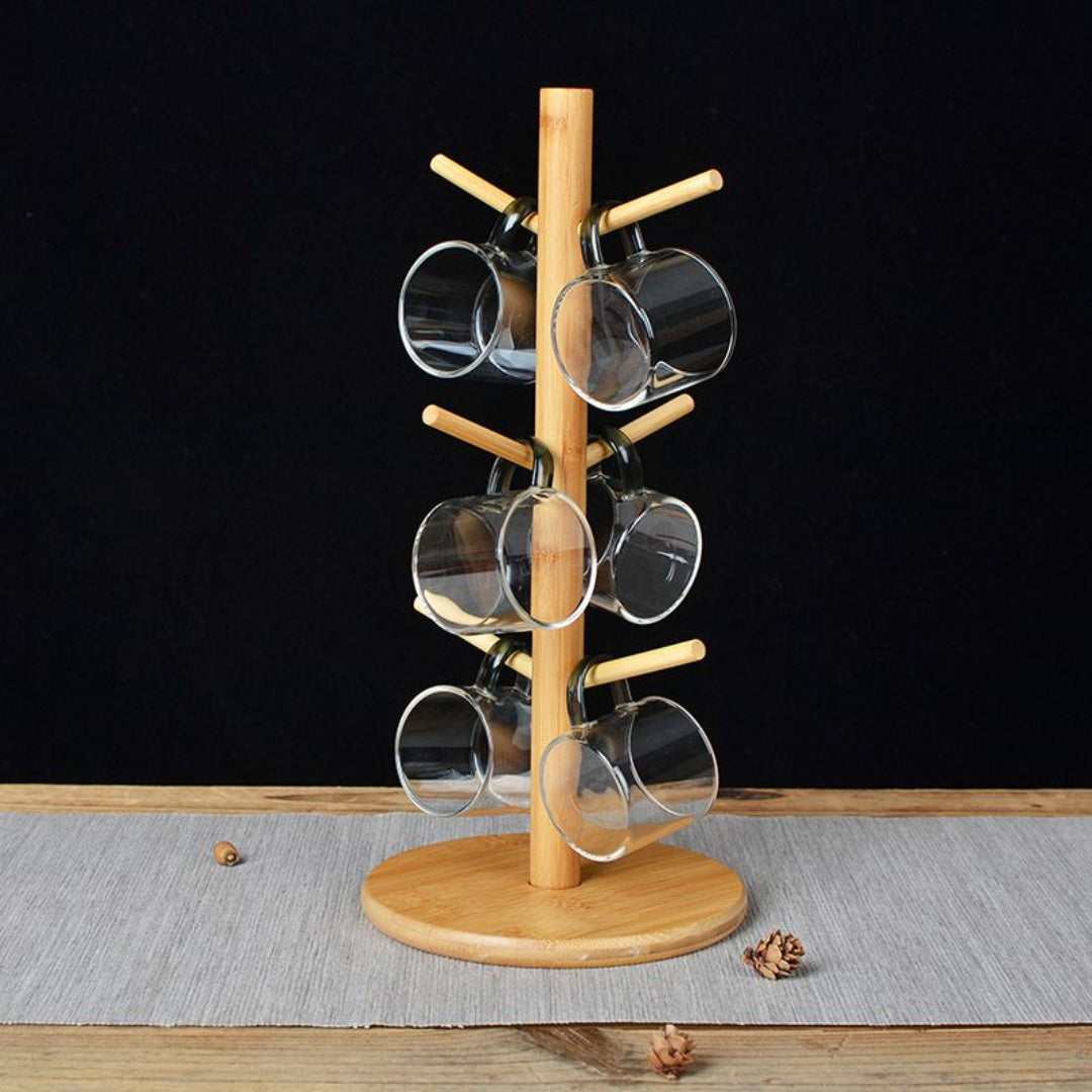 Wooden mug tree with clear glasses on a black background