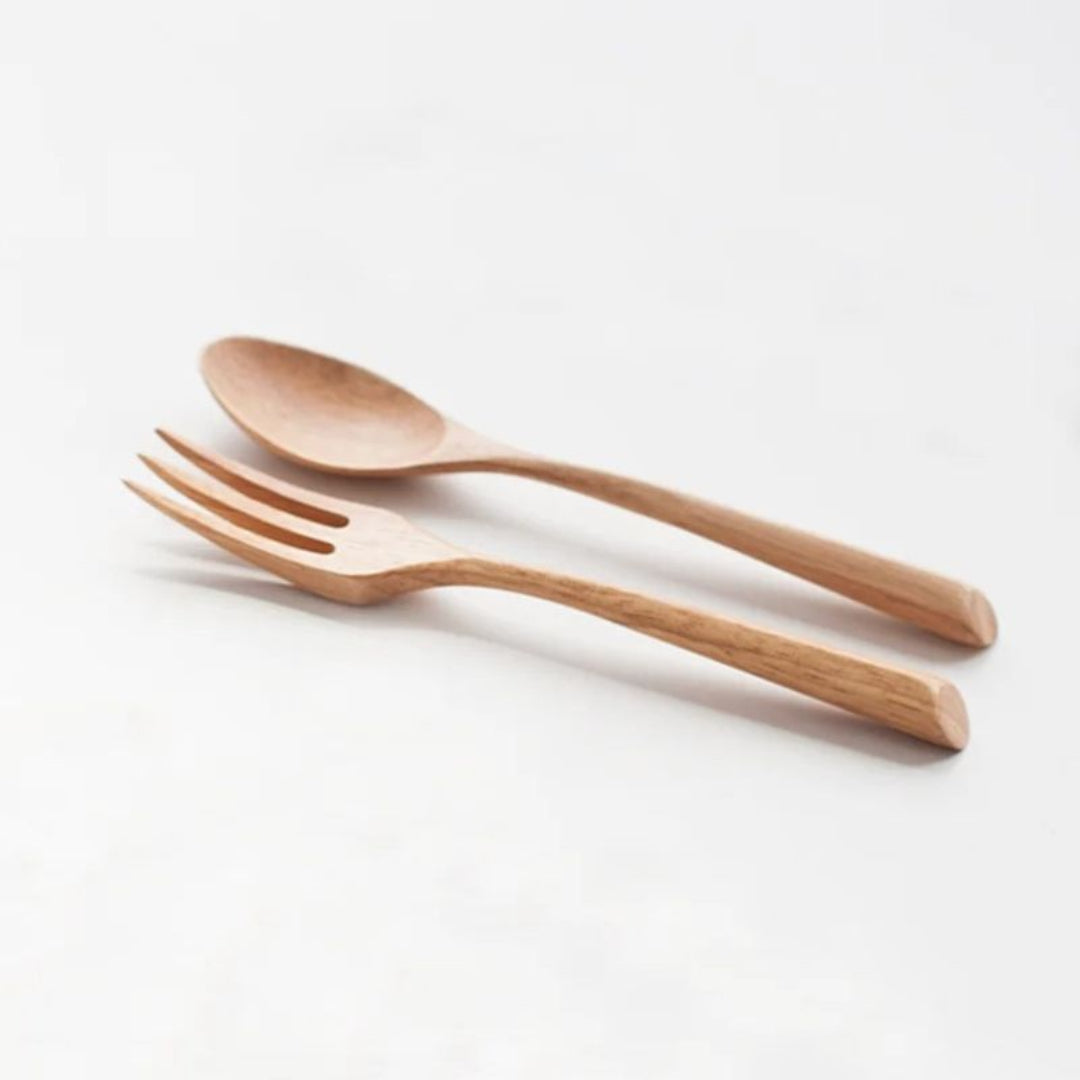 Wooden spoon and fork set on a white background