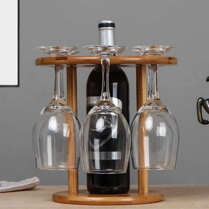 Wooden wine glass holder with three glasses and a bottle on a neutral background