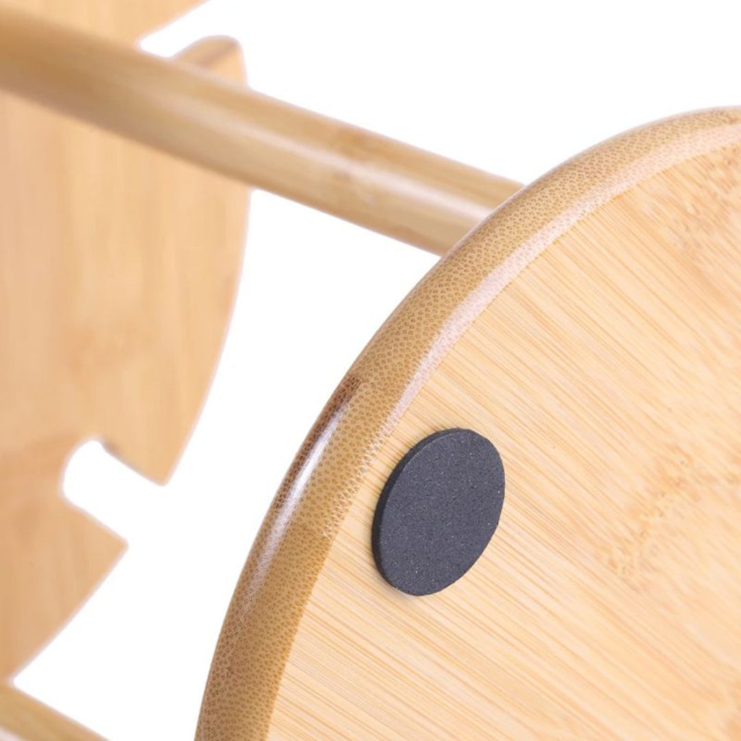 Close-up of a wooden chair with a black circular detail on a white background