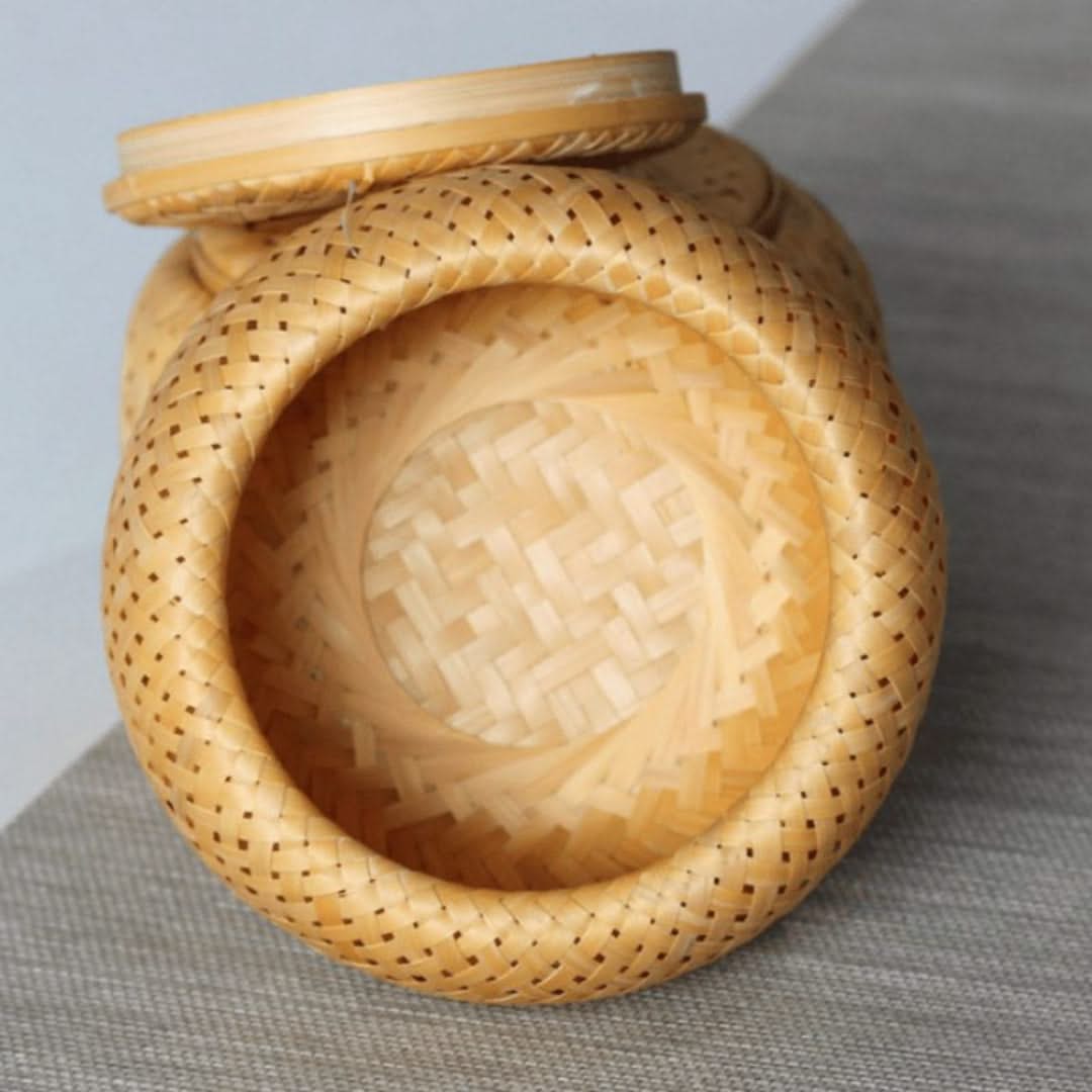 Woven basket with a lid on a gray surface
