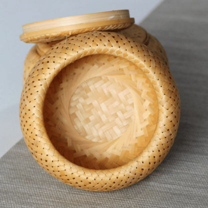 Woven basket with a lid on a gray surface